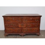 An 18th century oak coffer, in the form of a dresser base,