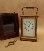 A French brass carriage clock, with a white enamel rectangular dial and Roman numerals inscribed J.