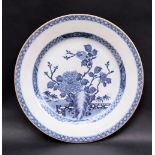 A Chinese porcelain charger, decorated to the centre with a fence pattern, trees and flowers, 31.