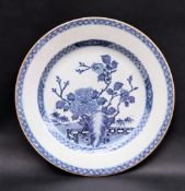 A Chinese porcelain charger, decorated to the centre with a fence pattern, trees and flowers, 31.