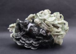 A Jadeite carving of a pig and figure from the Chinese fable Journey to the West,