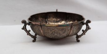 An Indian white metal dish of lobed form with three scrolling handles,
