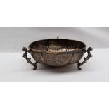 An Indian white metal dish of lobed form with three scrolling handles,