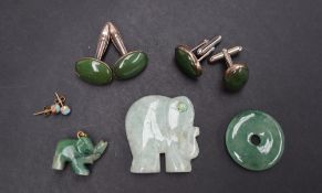 A jade disc together with two pairs of jadeite cufflinks,