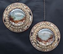 A pair of sea shell pictures with a domed glass centre surrounded by graduated shells,