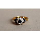 An 18ct yellow gold sapphire and diamond cluster ring,