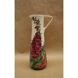 A Moorcroft pottery slender jug decorated in the Amberwood pattern, by Rachel Bishop, dated 2002,