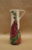 A Moorcroft pottery slender jug decorated in the Amberwood pattern, by Rachel Bishop, dated 2002,