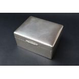 An Elizabeth II silver cigarette box of rectangular form with engine turned decoration, Sheffield,