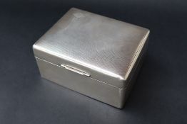 An Elizabeth II silver cigarette box of rectangular form with engine turned decoration, Sheffield,