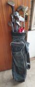 A golf bag containing numerous clubs including Ryder Low Pro,