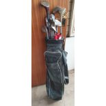 A golf bag containing numerous clubs including Ryder Low Pro,