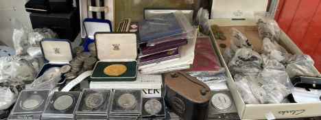 A Royal Mint Investiture medal, cased together with coin sets, crowns, 50 pence pieces,