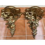 A pair of gilt gesso leaf carved wall brackets