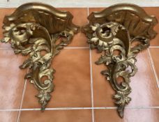 A pair of gilt gesso leaf carved wall brackets