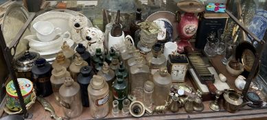 A apothecaries pill rolling machine together with a collection of pharmacy bottles,