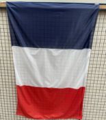 A large French Flag on a pole