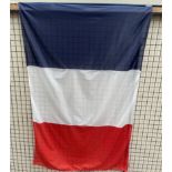A large French Flag on a pole
