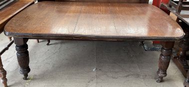A large Victorian oak extending dining table,