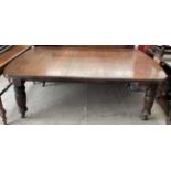 A large Victorian oak extending dining table,