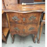 A 20th century burr walnut chest with two drawers on shaped legs and sabot feet,