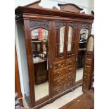 A late Victorian / Edwardian walnut six piece bedroom suite comprising a triple wardrobe,