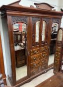 A late Victorian / Edwardian walnut six piece bedroom suite comprising a triple wardrobe,
