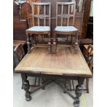 A 20th century oak extending dining table and four chairs