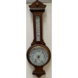 An oak cased aneroid barometer with alcohol thermometer