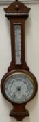 An oak cased aneroid barometer with alcohol thermometer