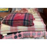 A pink Welsh wool blanket together with other blankets