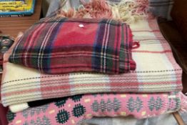 A pink Welsh wool blanket together with other blankets