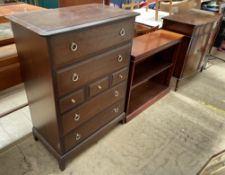 A stag chest of drawers together with a mahogany side cabinet and a mahogany bookcase