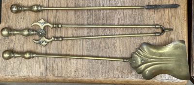 A set of three brass fire irons, including a shovel,