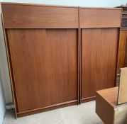 An Austin Suite teak bedroom suite comprising two wardrobes and a dressing table