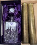 An Edinburgh crystal decanter together with a pair of brass shell cases