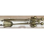 A set of three brass fire irons and an andiron