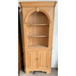 A pine corner cupboard with shelves to the top and a cupboard base together with a cheval mirror