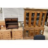 A modern wall unit with a glazed top together with a reproduction mahogany bookcase and a pair of