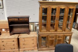 A modern wall unit with a glazed top together with a reproduction mahogany bookcase and a pair of