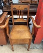 An Edwardian satin walnut commode chair