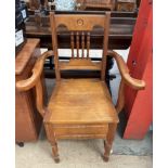 An Edwardian satin walnut commode chair