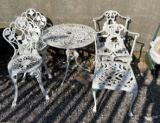 A white painted garden table and four chairs