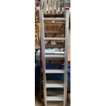 A wooden step ladder together with an aluminium ladder