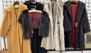 A fur stole together with two fake fur coats,