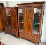 An Edwardian walnut wardrobe, with a pair of mirrored doors and a drawer to the base,