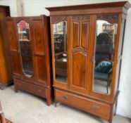 An Edwardian walnut wardrobe, with a pair of mirrored doors and a drawer to the base,