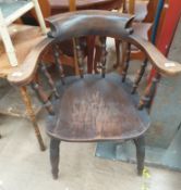 A smokers bow elbow chair with a turned spindle back
