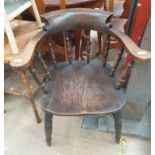 A smokers bow elbow chair with a turned spindle back