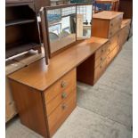 A mid 20th century teak dressing table together with two chests of drawers and a laundry box,